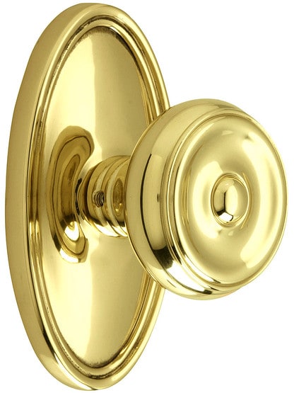 Oval Rosette Set With Waverly Knobs in Polished Brass.